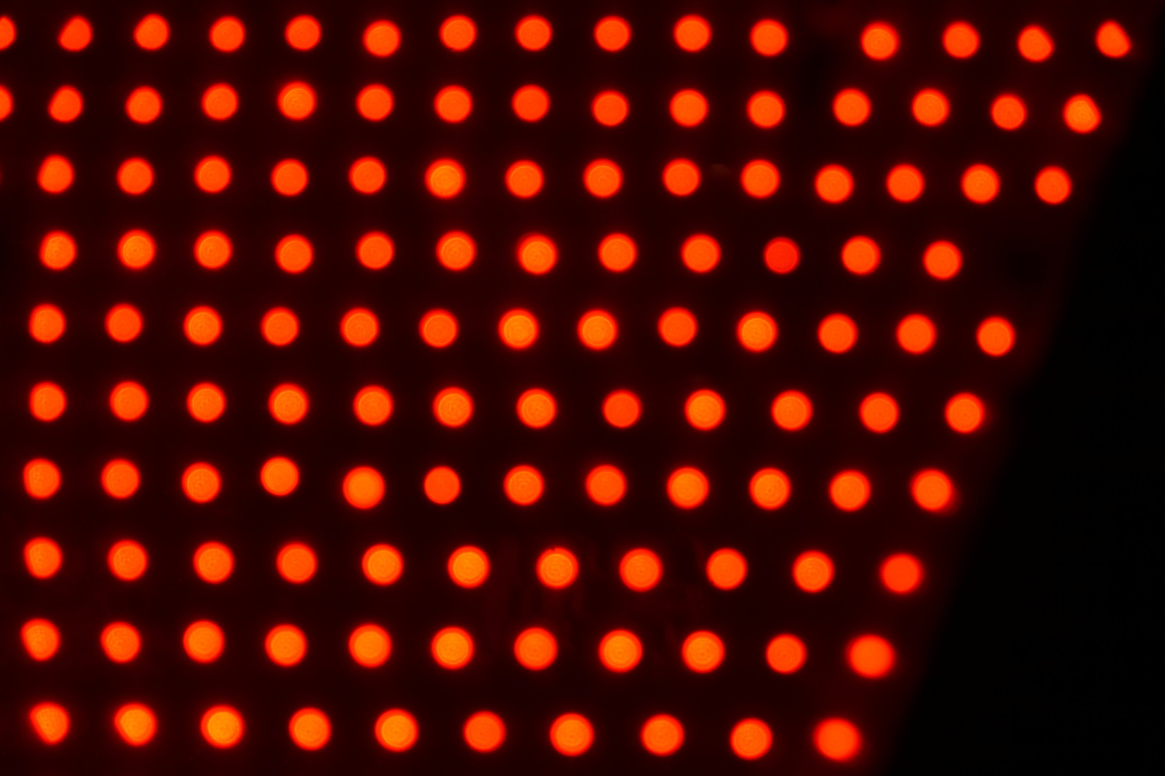 Red light therapy panel with glowing LEDs